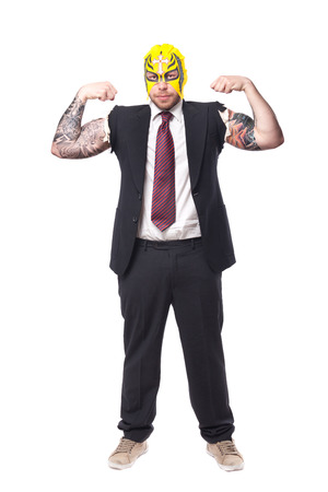 businessman in a suit with no sleeves and tattoo on his arms wearing a wrestling maskの写真素材