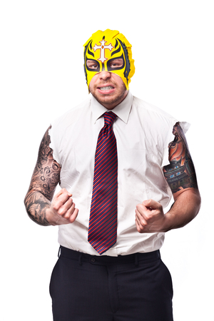 businessman in a suit with no sleeves and tattoo on his arms wearing a wrestling maskの写真素材