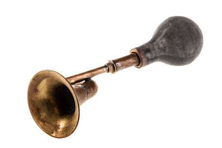 an old manual air horn isolated over a white background