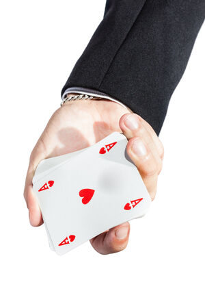 an elegant young businessman showing an ace of hearts in his hand
