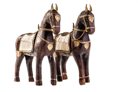 an ancient statuette depicting a horse isolated over a white backgroundの写真素材