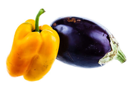a yellow bell pepper and an eggplant fruit isolated over a white backgroundの写真素材