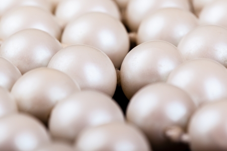 a necklace made of beautiful pearls on a black velvet clothの写真素材