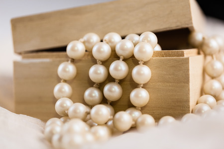 an ornated wooden box containing a beautiful pearl necklaceの写真素材