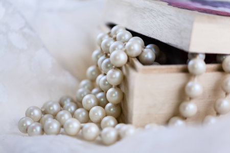 an ornated wooden box containing a beautiful pearl necklace