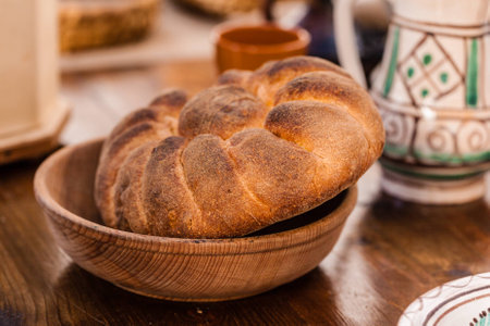a homemade loaf of bread on a wooden table in Italy