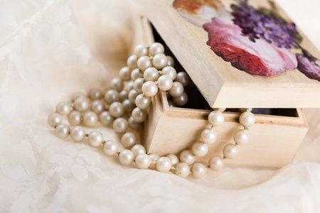 an ornated wooden box containing a beautiful pearl necklaceの写真素材