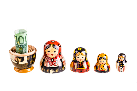 Russian doll with euro inside isolated on white backgroundの写真素材