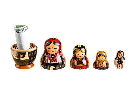 Russian doll with euro inside isolated on white backgroundの写真素材