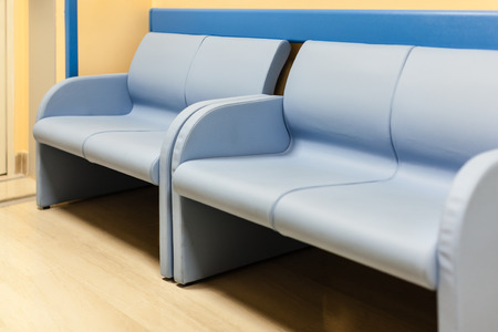 blue lounge benchs in an hospital corridorの写真素材