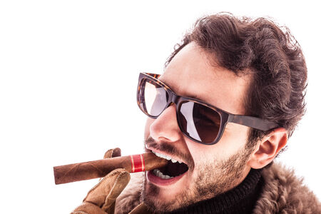 a young and rich man wearing a sheepskin coat isolated over a white background holding a cigar