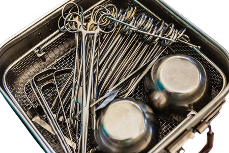 surgical instruments and tools including scalpels, forceps and tweezers in a metal container