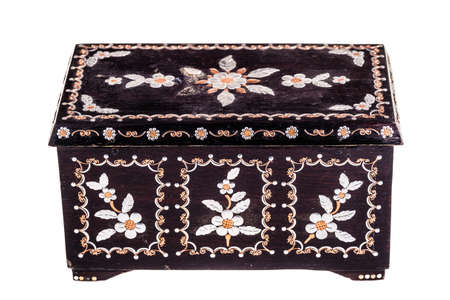 an old romanian black wooden box with mother of pearl decorations isolated over a white bachgroundの写真素材