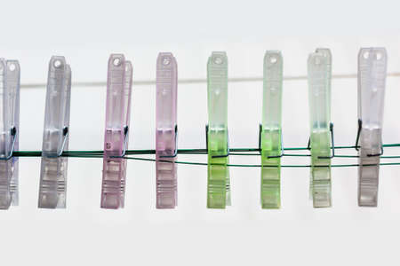 some coloured clothes pegs isolated over a white backgroundの写真素材