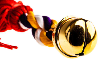 a small jingle bell isolated over a pure white backgroundの写真素材