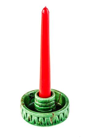 Retro antique candlestick with red candle isolated over a white backgroundの写真素材