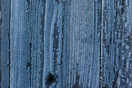 background texture of wooden planks or wooden wall covered with hoarfrost ice crystal in winterの写真素材