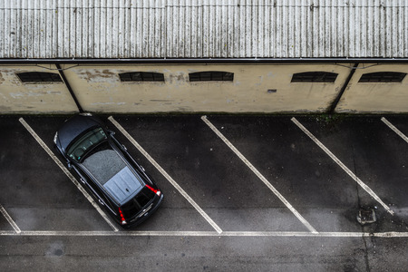 a small parking lot seen from above, with only one carの写真素材
