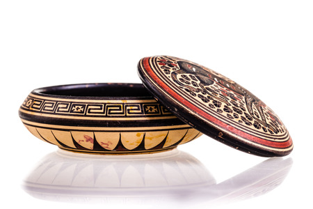 a small round ancient decorated ceramic box isolated over a white backgroundの写真素材