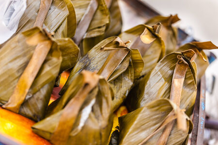 traditional thai sticky rice dumpling on sale in a street market in bangkokの写真素材