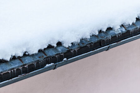 detail of a roof covered with thawing snow