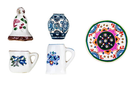 a collection of colorful bulgarian miniature tableware isolated over a white backgroundの写真素材