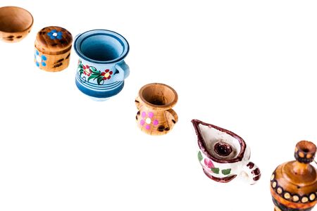 a collection of colorful bulgarian miniature tableware isolated over a white backgroundの写真素材