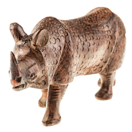 a wooden rhino statuette isolated over a white backgroundの写真素材