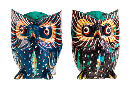 two wooden owls isolated over a white backgroundの写真素材