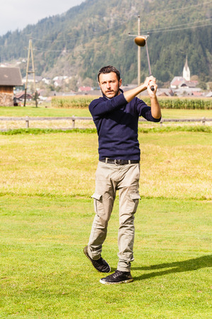 a golf player making a swing on a vibrant beautiful golf courseの写真素材