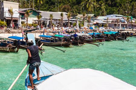 The main pier of the tropical thai island named Phi Phi, with a lot of colorful longtail boatsのeditorial素材