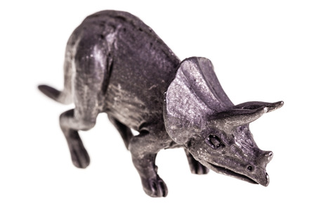 a metal triceratops figurine isolated over a white backgroundの写真素材
