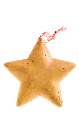 a star shaped gingerbread christmas ornament isolated over a white backgroundの写真素材
