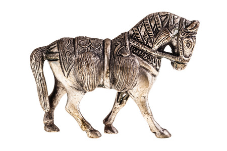an ancient metal horse figurine isolated over a white backgroundの写真素材