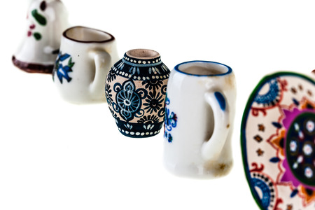 a collection of colorful bulgarian miniature tableware isolated over a white backgroundの写真素材
