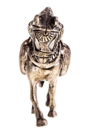 an ancient metal horse figurine isolated over a white backgroundの写真素材