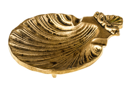 a shell shaped bronze ashtray isolated over a white background