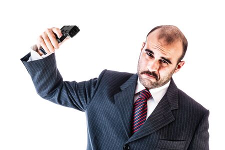 portrait of a classy businessman or mobster or security guard holding a gun isolated over a white backgroundの写真素材