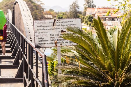 a warning sign on the famous bridge on the river Kwai in Kanchanaburi province, Thailandの写真素材