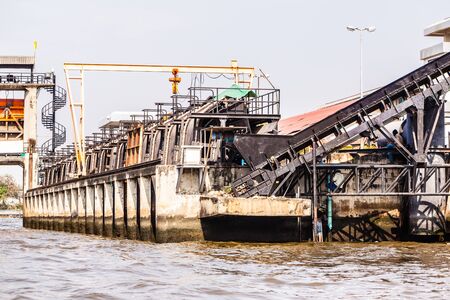 a garbage disposal plant with a conveyor belt in Thailandの写真素材
