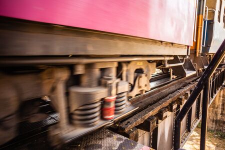 a passenger train crossing the famous bridge on the river Kwai, in Thailandの写真素材