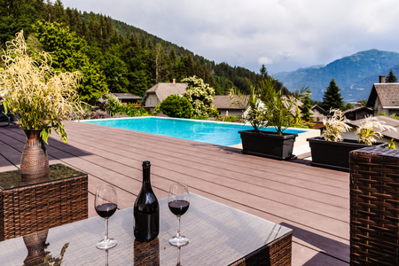 a luxurious lounge on the poolside of a beautiful big poolの写真素材