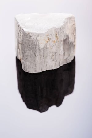 close up shot of a fragment of selenite mineral on a dark surfaceの写真素材