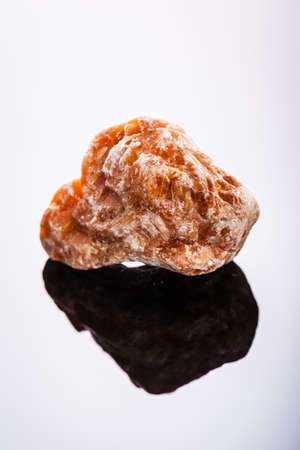 close up shot of a fragment of calcite mineral on a dark surfaceの写真素材