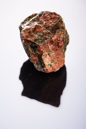 close up shot of a fragment of unakite mineral on a dark surfaceの写真素材