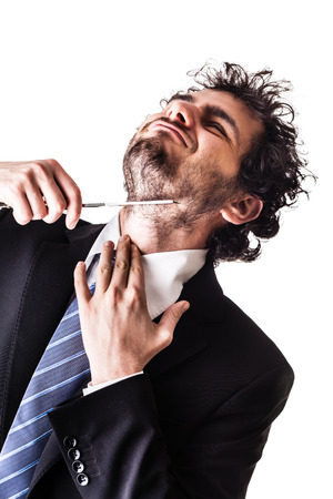 a young and handsome businessman holding a cut-throat razor isolated over a white backgroundの写真素材