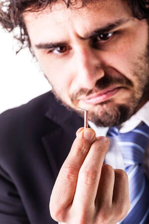a young and handsome businessman with a tiny red firecrackerの写真素材