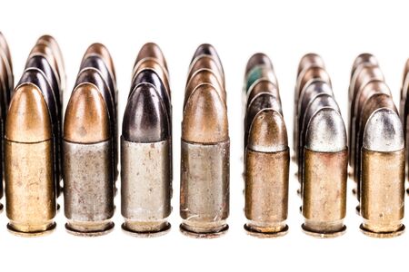 a lot of old handgun pistol bullets ammo isolated over a white background