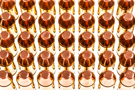 a lot of 9mm handgun bullets arranged in rowsの写真素材