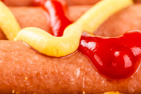 macro shot of some wiener sausages with mustark and ketchupの写真素材